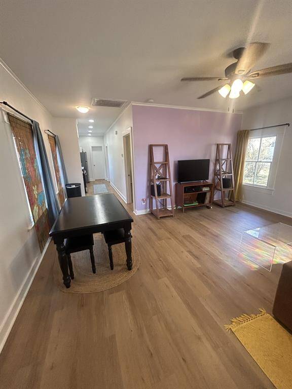 Looking from the front door into the living room with kitchen, bedrooms & bath to the left.