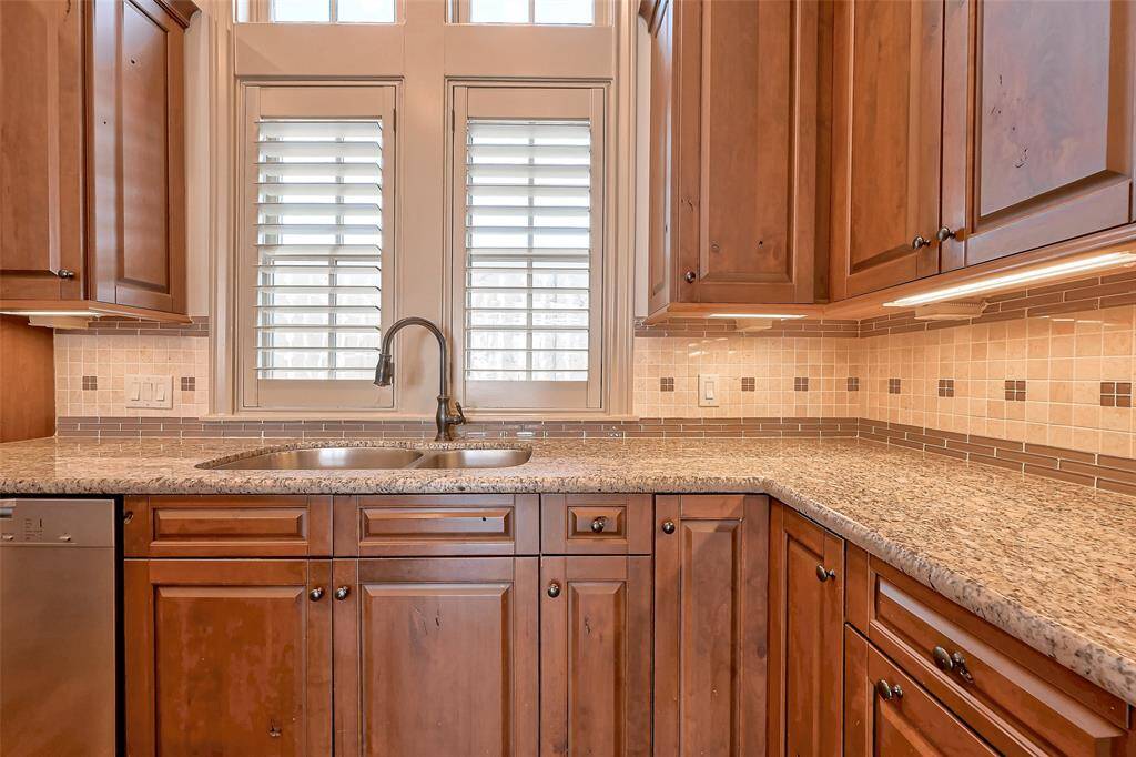Brookhaven wood cabinets. Granite countertops and tile backsplash with design. Lazy susan, deep pots/pan drawers/cabinet for trash recycle across from sink.