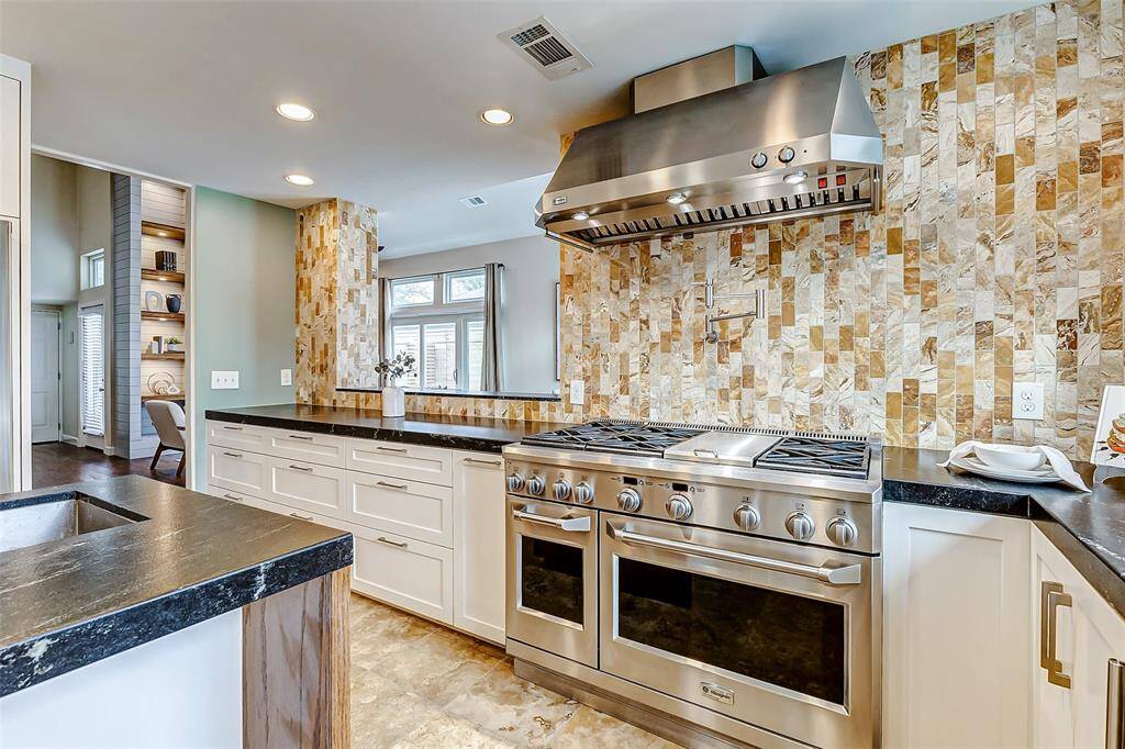 Modern chef's kitchen with premium stainless steel appliances.