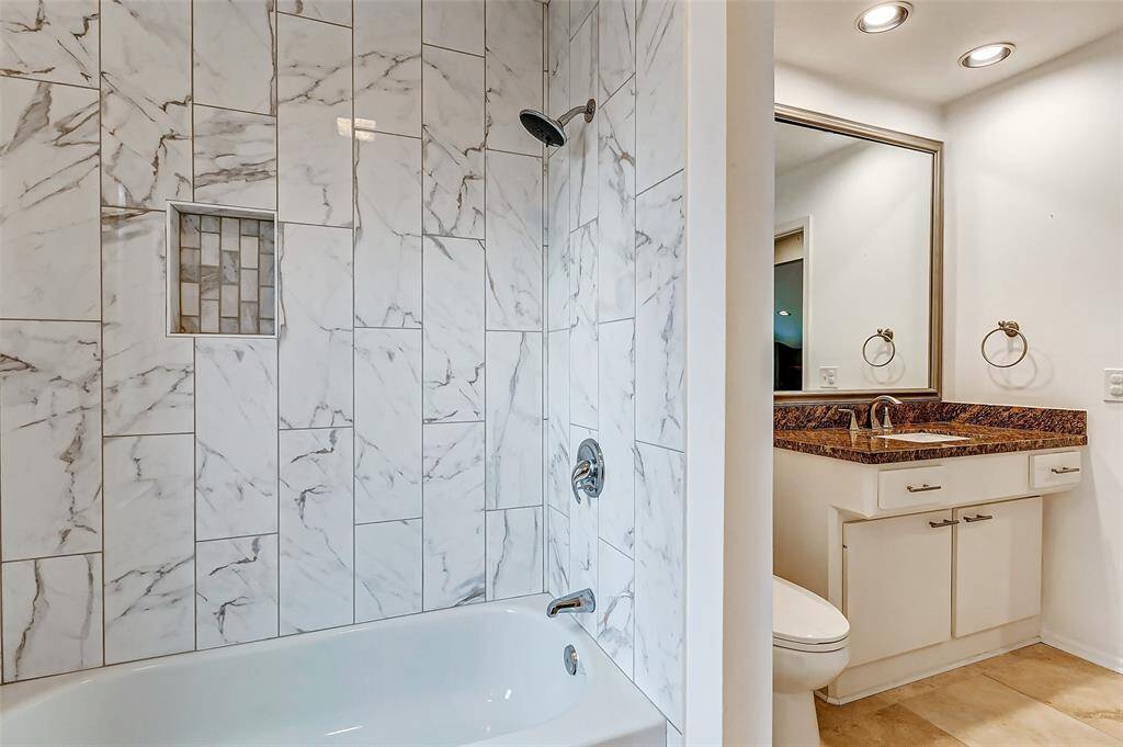 Elegant, newly updated tilework in the guest bathroom's tub/shower.