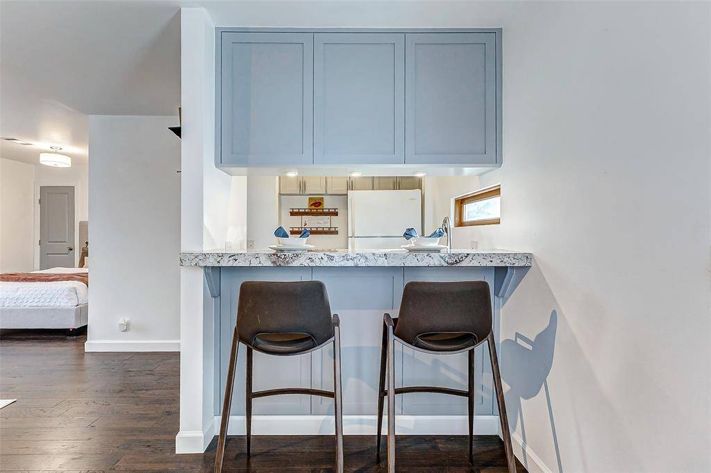 Charming garage apartment with a full kitchen and inviting breakfast bar.