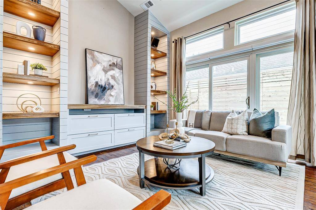 Elegant sliding doors open to a charming side courtyard.  Anderson windows and sliding doors were updated around 2012.