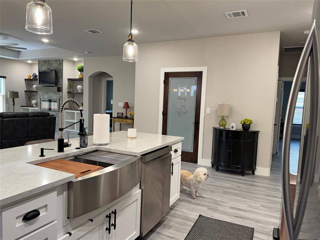From the kitchen, living room and primary bedroom to the left.