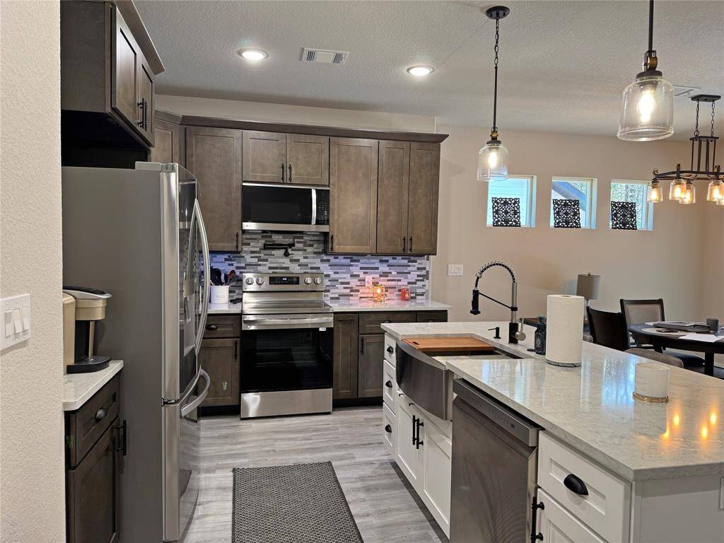 Kitchen with lots of cabinets and open to the living room.