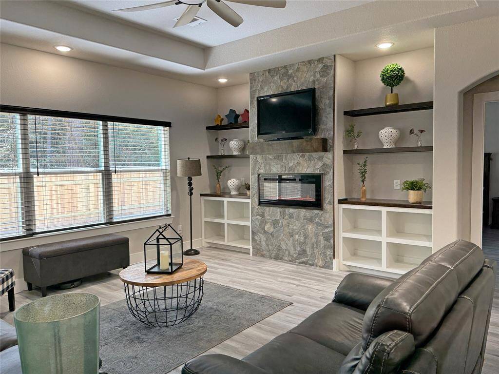 Lots of natural light in this living room and an electric fireplace.