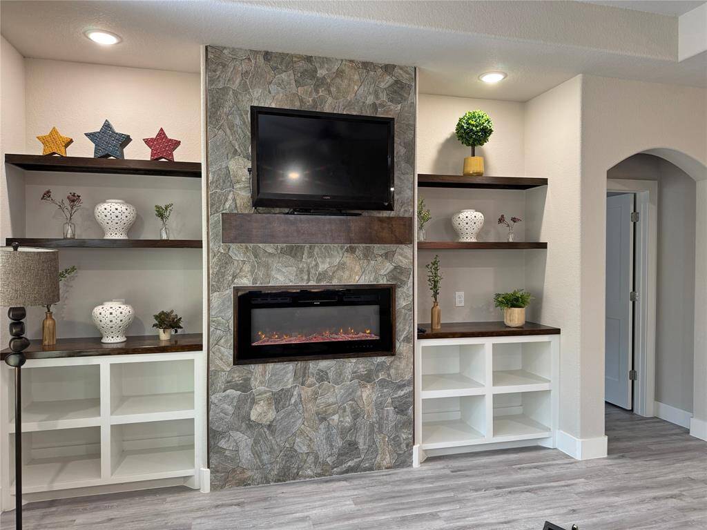 Built in shelving and electric fireplace.