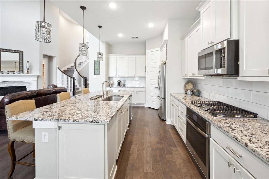 Elegant, pristine cabinets enhance the kitchen's modern appeal.
