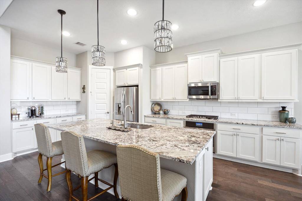 Stunning designer pendants illuminate the island.