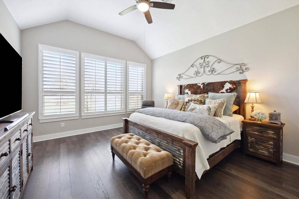Experience the warmth of natural light and elegant wood flooring in the Primary Suite.