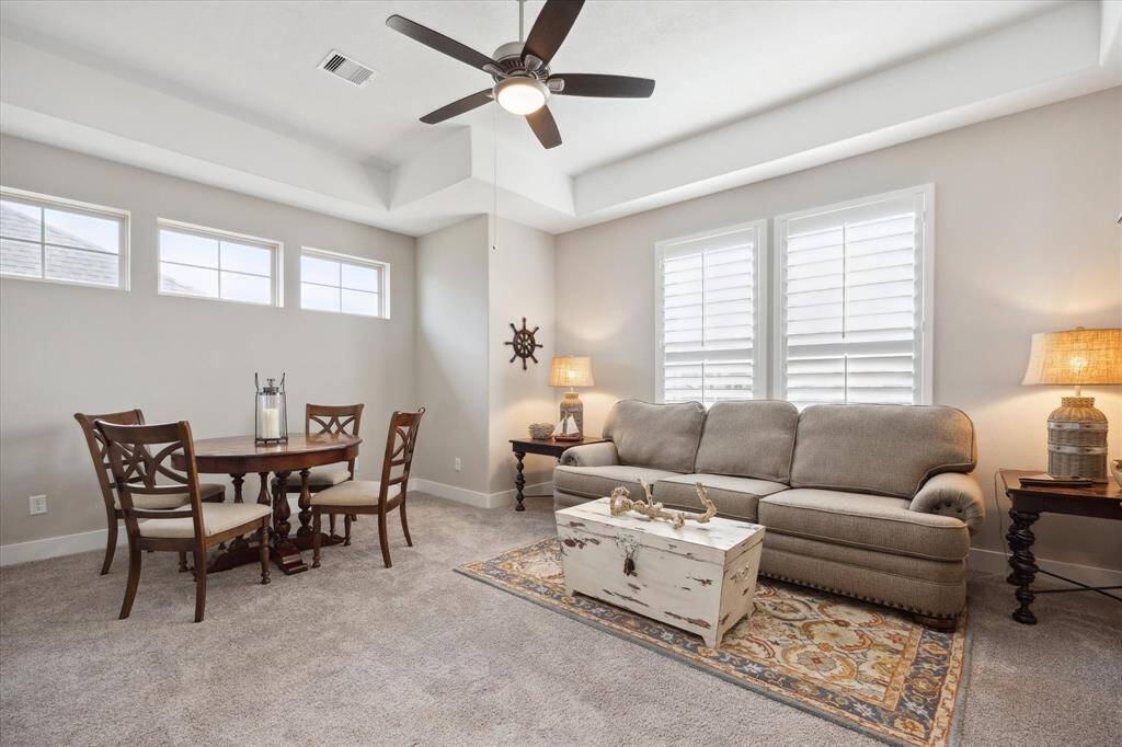 Spacious and inviting game room perfect for entertaining, featuring ample natural light, cozy seating, and a versatile area for family fun.