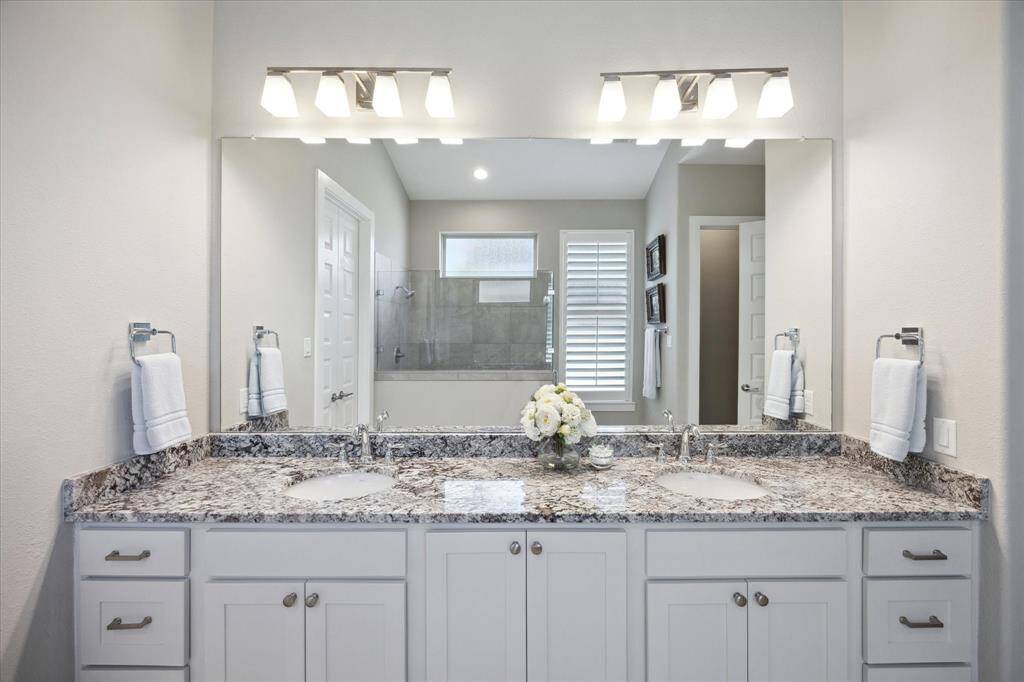 Discover the elegance of the primary bath, featuring a spacious double vanity and modern finishes.