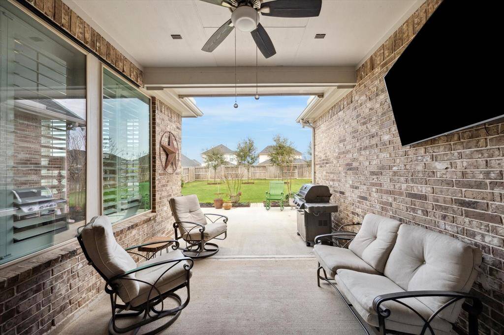 Relax and entertain in style on this spacious covered patio, perfect for enjoying the outdoors year-round.