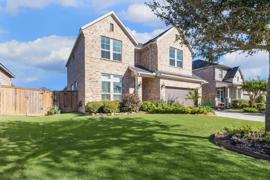 Lush, landscaping enhanced by outdoor landscape lighting,creates a welcoming and vibrant curb appeal.