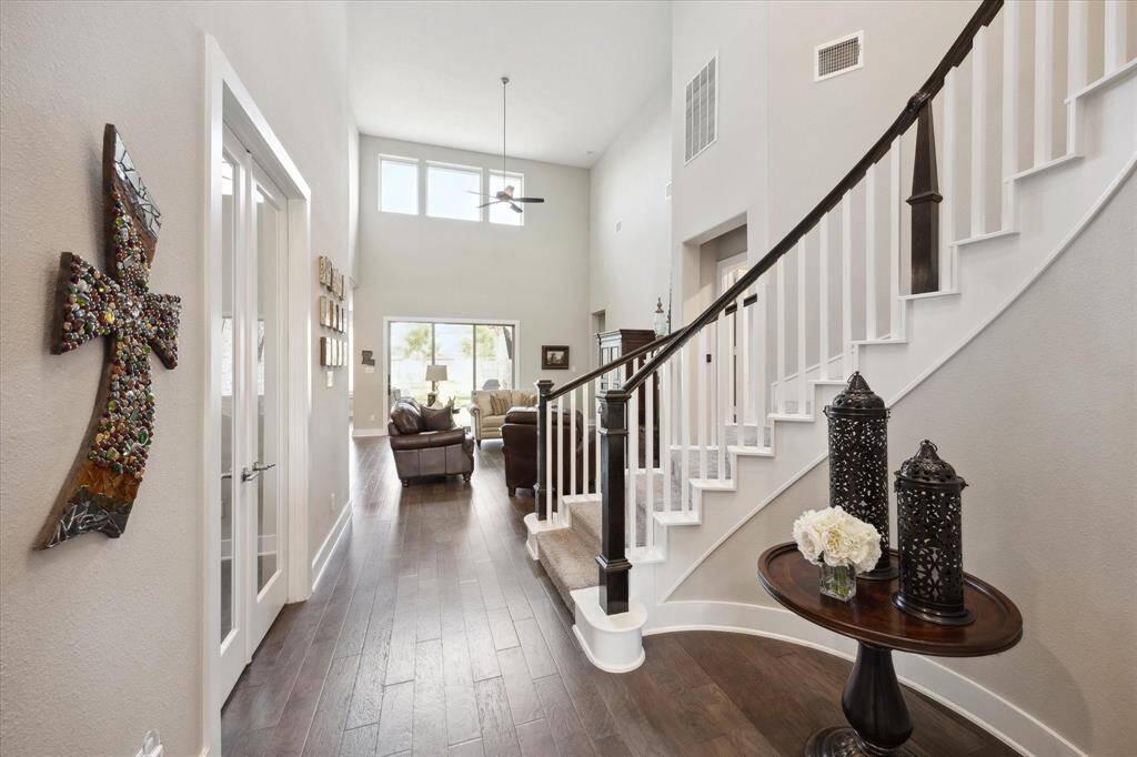 Discover the elegance of a grand staircase and pristine wood floors as you enter.