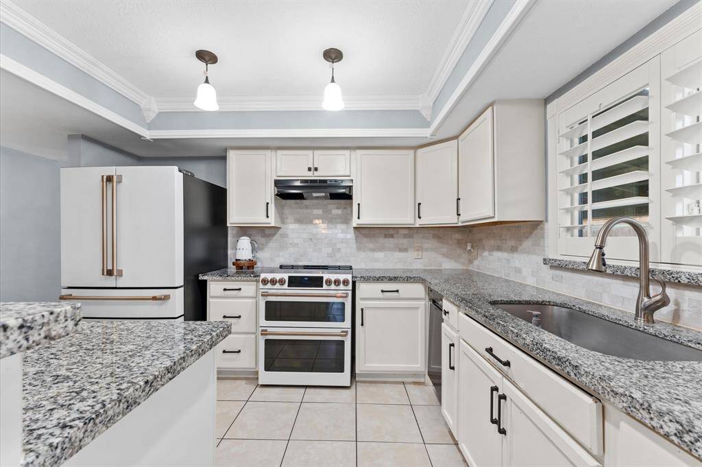 - Gorgeous remodeled kitchen with granite countertops and ample cabinets.