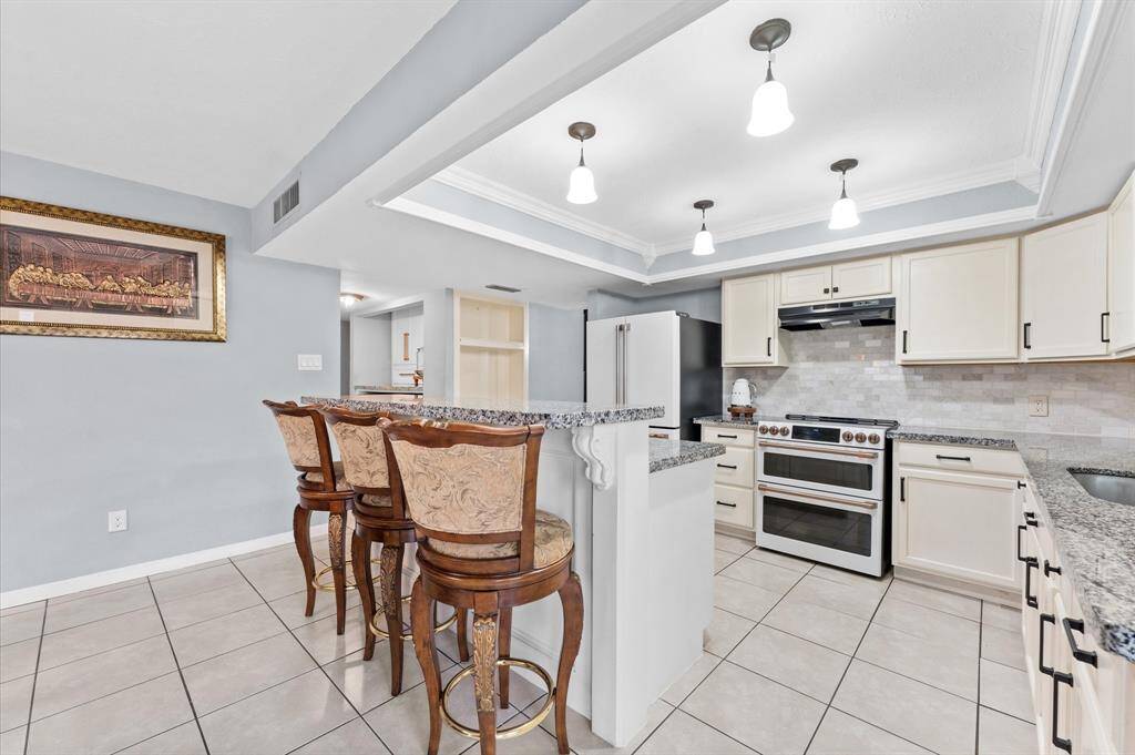 Gorgeous remodeled kitchen with granite countertops and ample cabinets.