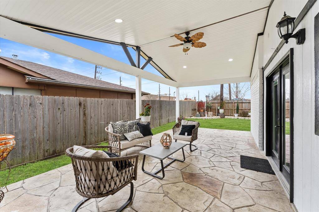 Covered patio leading to a spacious backyard.
