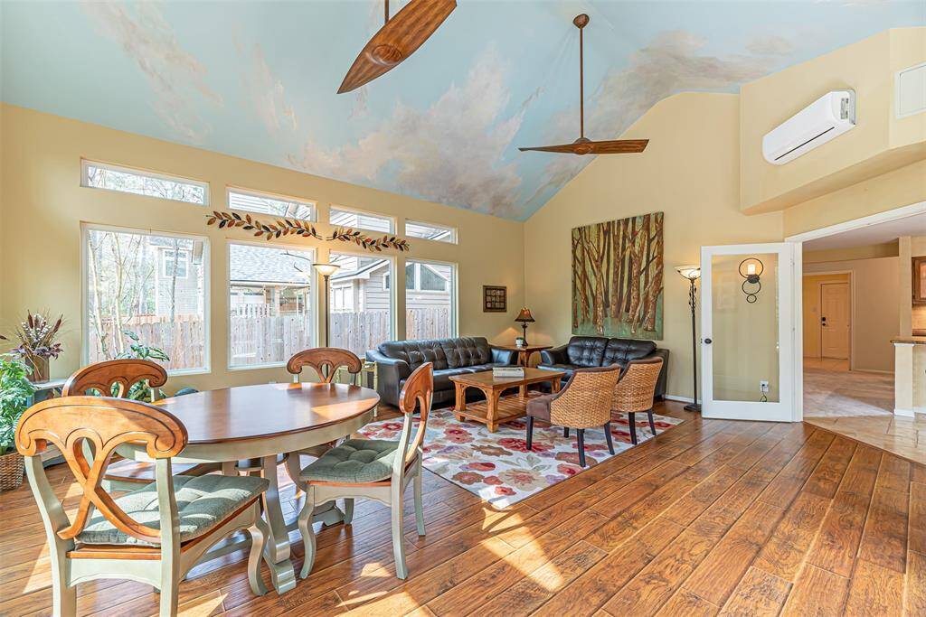 Sun room has glass framed double doors for entry and mini split.