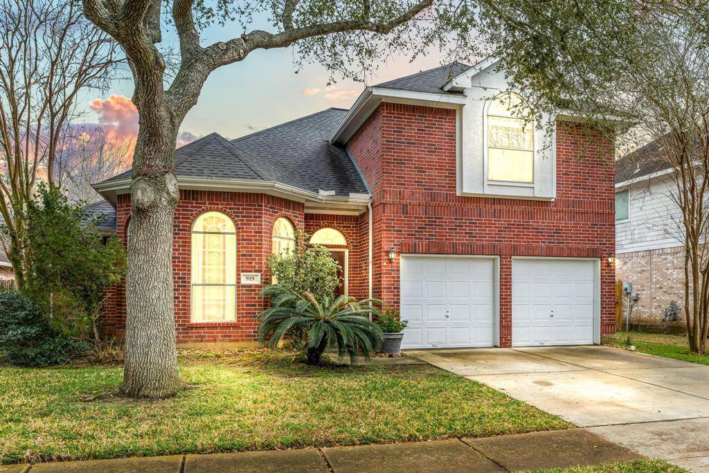 Welcome to 919 Tennyson Dr, a charming home nestled on a peaceful street in Southdown and zoned to Pearland ISD! This beautiful brick home boasts stunning curb appeal with its well-manicured lawn, mature trees, elegant arched windows, and inviting entryway. The double-wide driveway leads to a spacious two-car garage, while warm outdoor lighting enhances the home's classic charm. A perfect blend of comfort and style awaits.