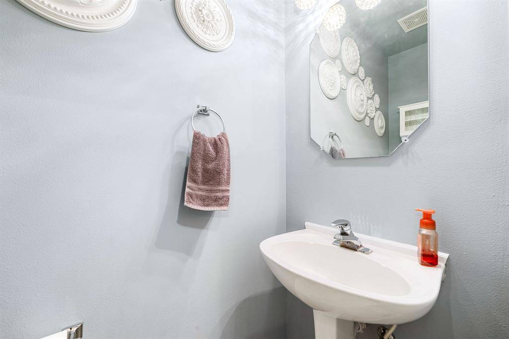 This lovely half bathroom exudes modern charm with a stylish vanity, contemporary fixtures, and a fresh neutral palette—creating a welcoming space for guests.