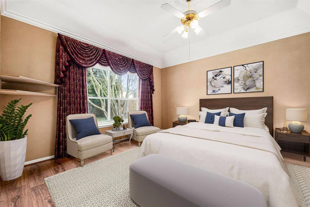 What a wonderful place to come home to, this stunning primary suite greets you with gorgeous wood style floors, a warm custom paint, high ceiling, crown molding, ceiling fan with lighting, lovely arched windows allowing in natural light brightening up this spacious primary bedroom, with extra space for a seating area. *Virtually Staged
