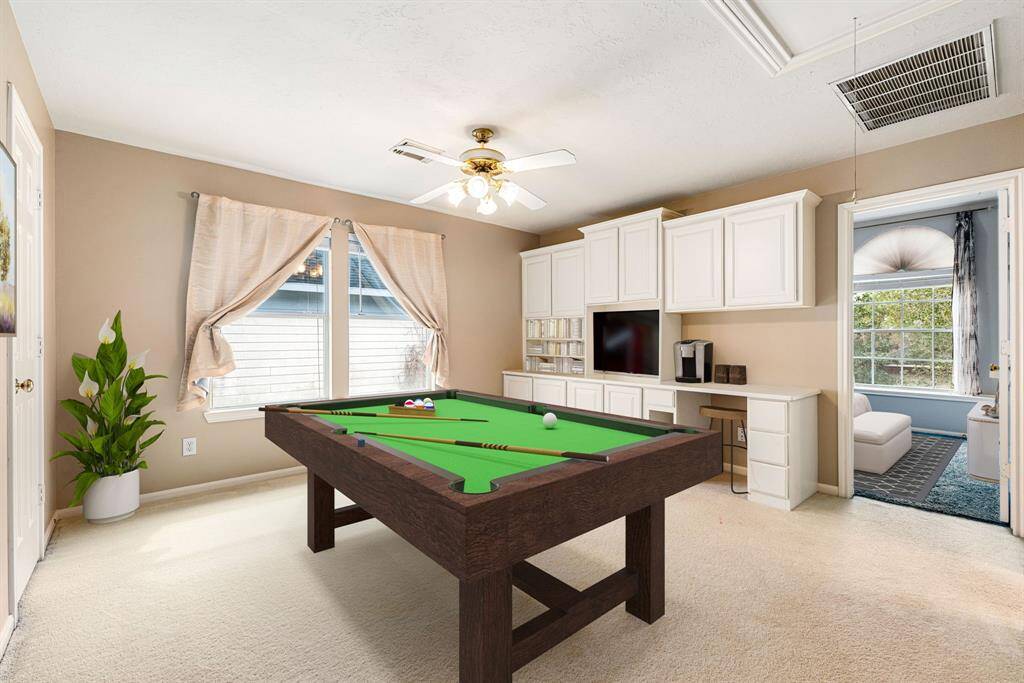 Perfect for entertaining is this amazing game room!  Right upstairs this space would be a fabulous teen hangout, media room, or adult game room complete with pool table and big screen TVs. Featuring plush carpet, high ceilings, a ceiling fan, custom paint and large windows. *Virtually Staged