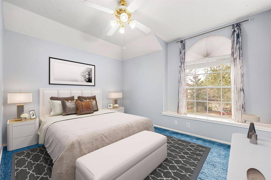 Secondary bedroom great for use as an in-law suite or guest suite features high ceilings, lovely modern ceiling fan, custom paint, plush carpet, space for seating area, direct access to the secondary bathroom and large window with plenty of natural light. *Virtually Staged