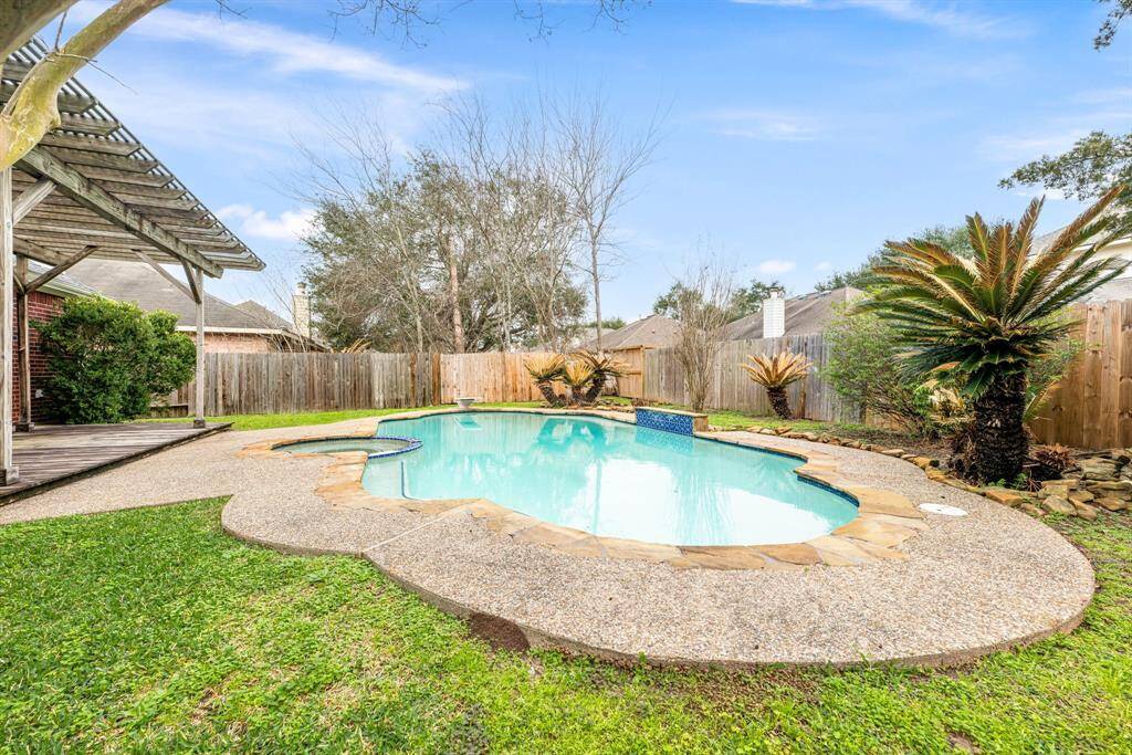 Soak up the sunshine by this sparkling pool, while the covered patio offers a cozy spot for alfresco dining and leisurely evenings. Perfect for hosting friends or unwinding with loved ones, this backyard is brimming with potential for your outdoor lifestyle.