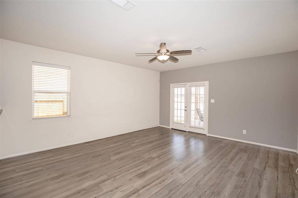 Huge family room with lovely French doors that lead to the backyard.