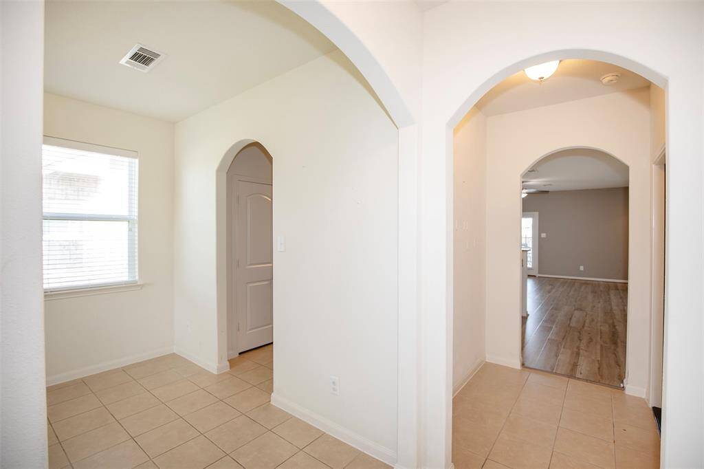 As you enter the home you are welcomed with lovely tile flooring and wonderful arched doorways.