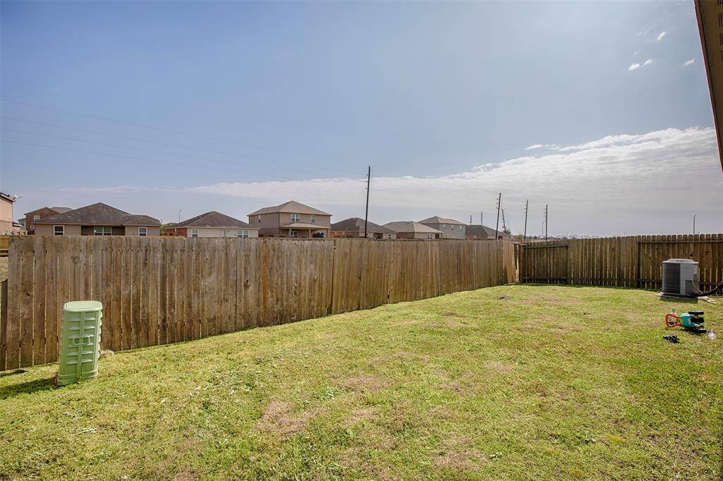 Spacious backyard has enough space for a garden.