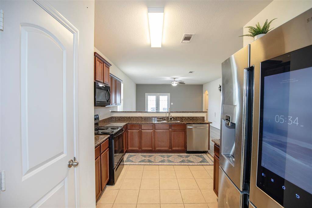 Entry to the kitchen from the dining area allows access to the pantry on the left.