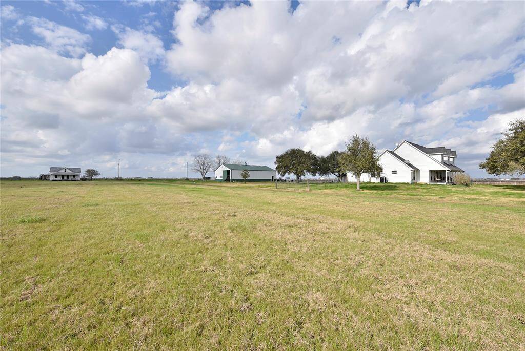 Expansive hay meadow with charming home, spacious barn, and cozy guest house. Ideal for serene country living.