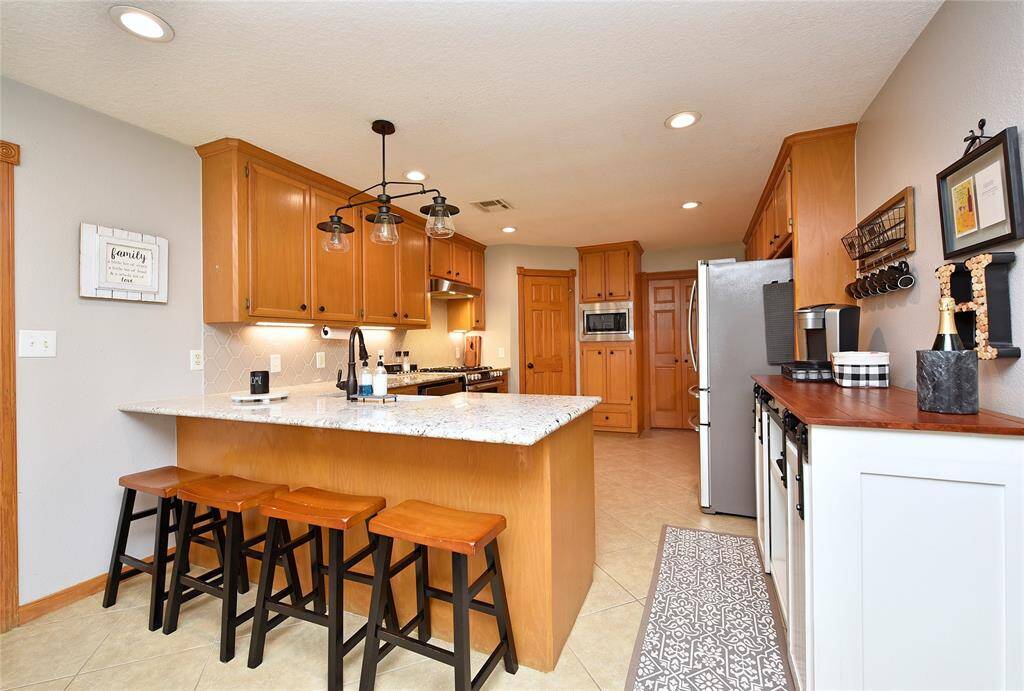 Spacious kitchen with a stylish breakfast bar. All cabinets are made with ash woods