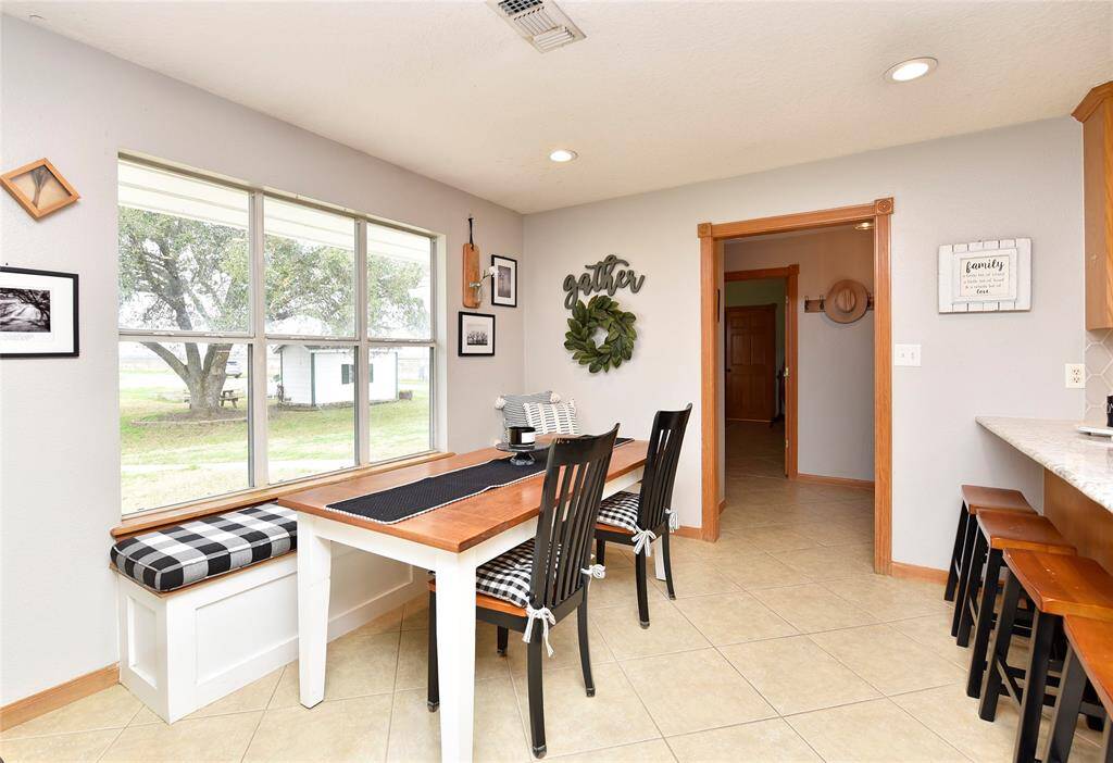 Cozy breakfast nook with abundant natural light and charming window views—perfect for family gatherings.