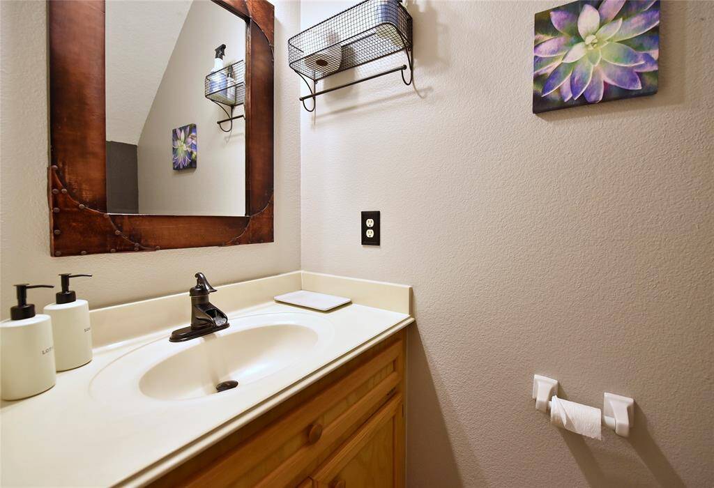 Elegant half bath with modern fixtures and stylish decor, perfect for guests.