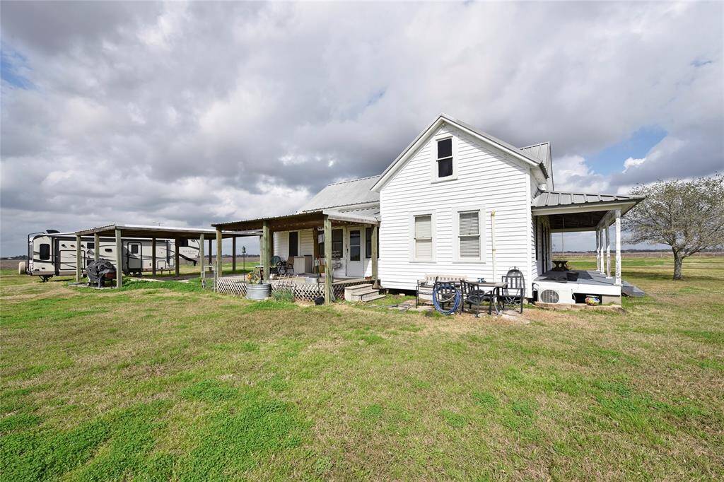 Charming home with a spacious covered back porch, perfect for relaxing or entertaining.