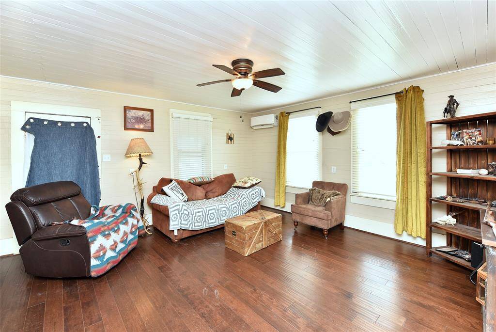 Cozy and inviting living space with hardwood floors, abundant natural light, and charming rustic accents. Perfect for relaxation and entertaining.