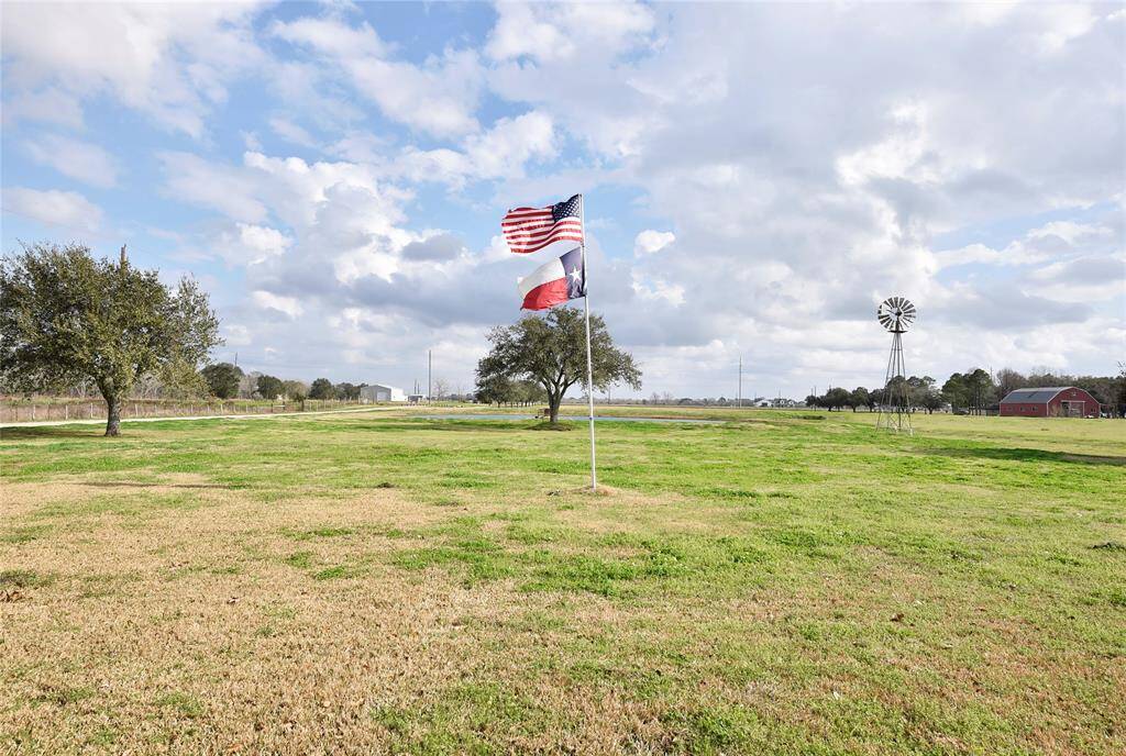 Enjoy serene views from the front porch overlooking a picturesque pond and expansive hay meadow.