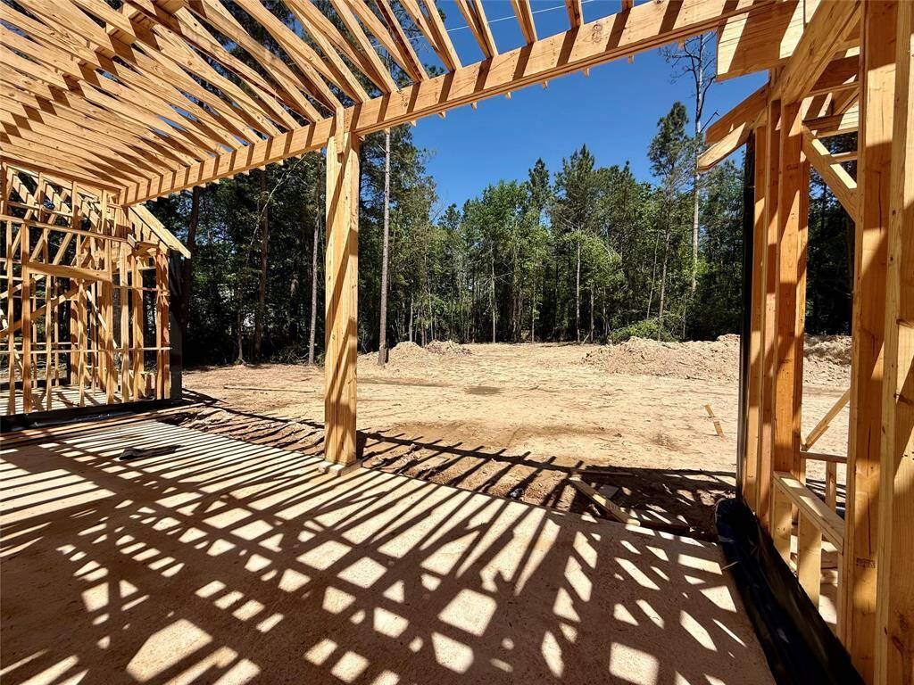 View of the backyard taken from the covered rear patio area. Plenty of room for a pool, plus more!