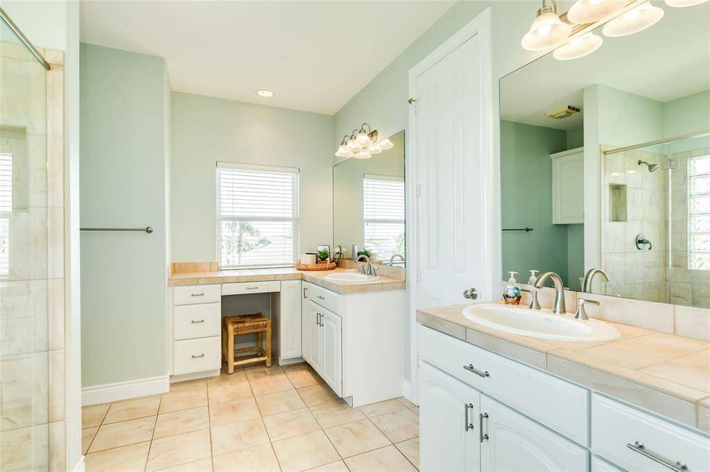 The owner's en-suite offers dual vanities, plenty of storage, and a large walk-in shower. The door between the vanities leads to the second walk-in closet.