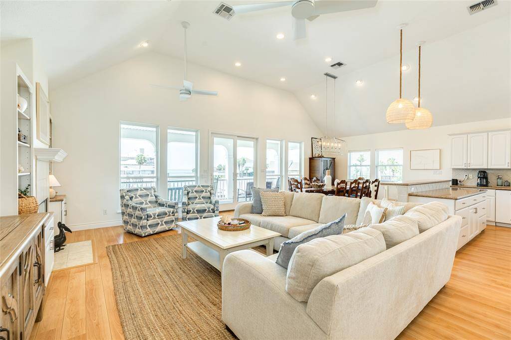 Bright and airy, the living offers soaring ceilings and a wall of windows allowing in tons of natural light