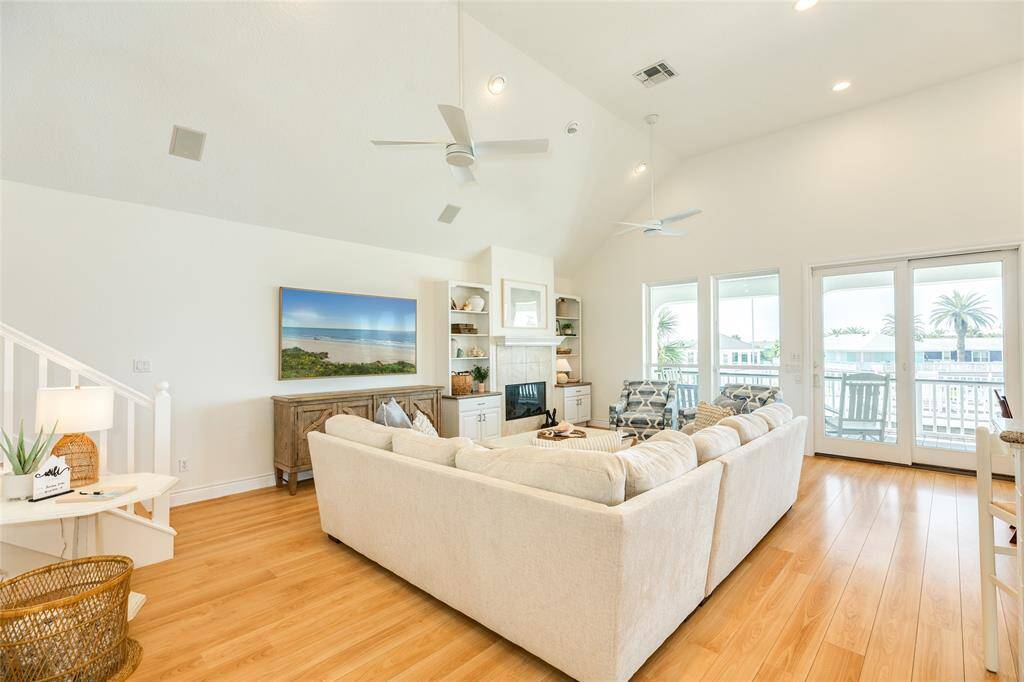 The comfortable living area features new furniture, built-in storage, and a fireplace.