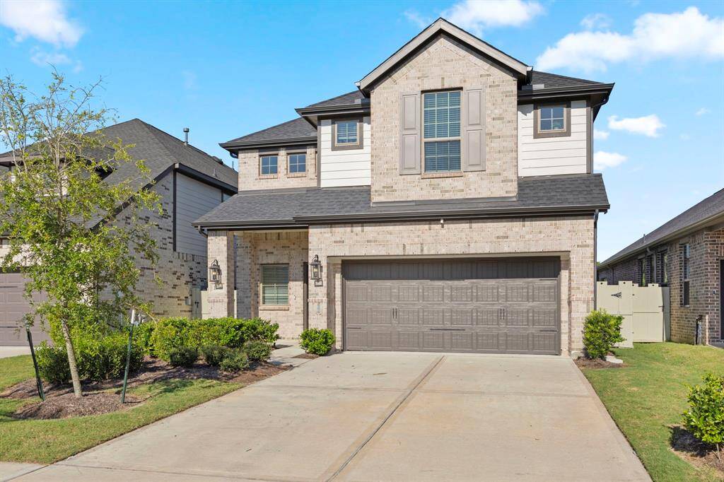 Very Modern front door and space for seating on this front patio.