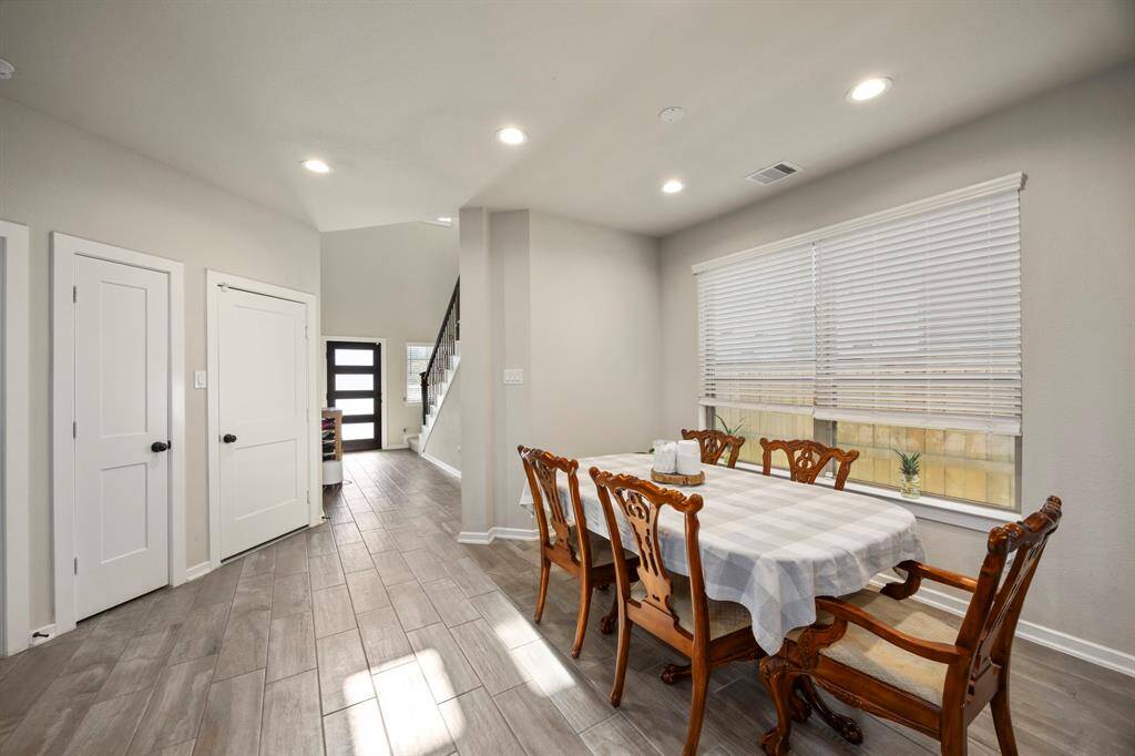 View of the dining area. Hallway closet and and entry to the garage to the left.
