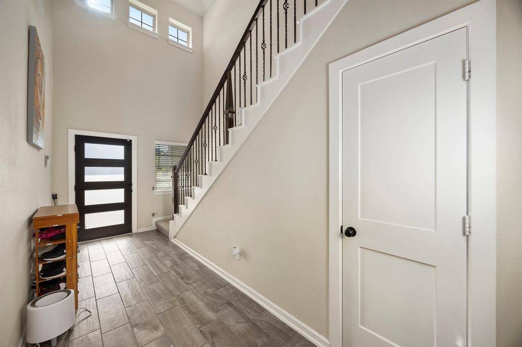 Plenty of natural lighting. Powder room just off the living area, under the stairs.