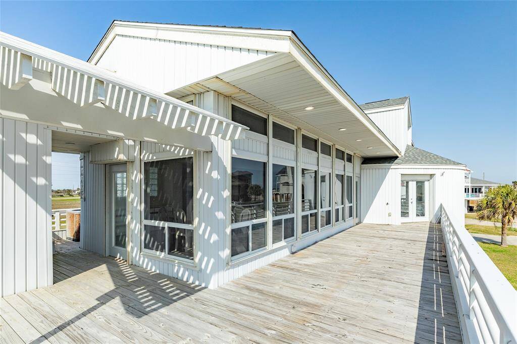 This deck is grand and will easily accommodate dining, sunbathing, or whatever your heart desires. The door on the left enters the dining room.