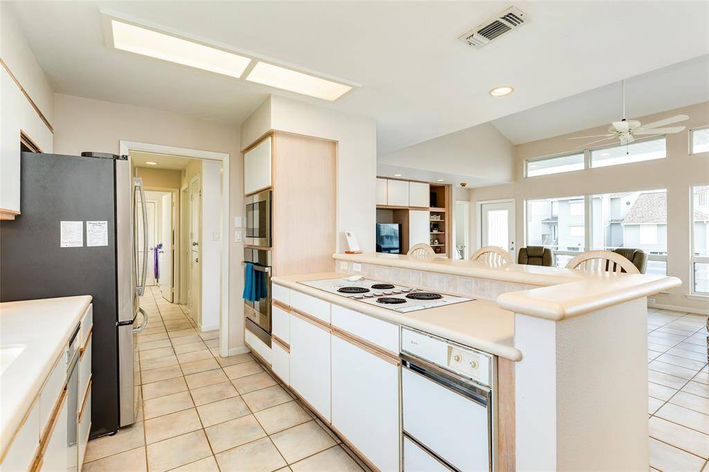 This efficient layout features both, a built-in wall oven and a built-in microwave. NOTICE: in the distance, beyond the kitchen, a functional dumb waiter to carry up groceries, luggage, etc.
