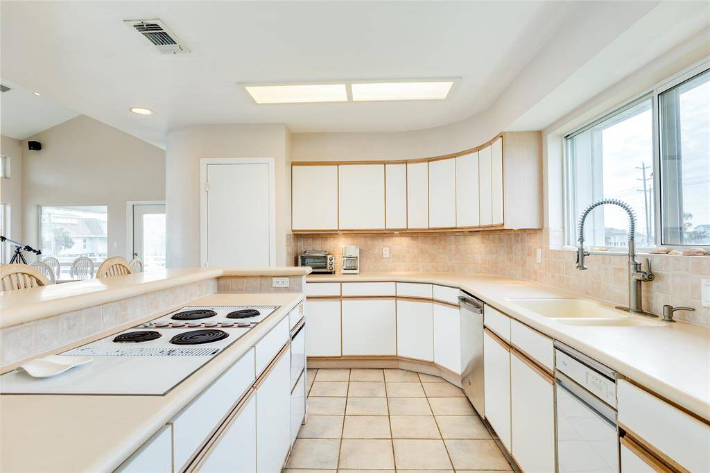 Abundant counter space and storage are offered in this kitchen.