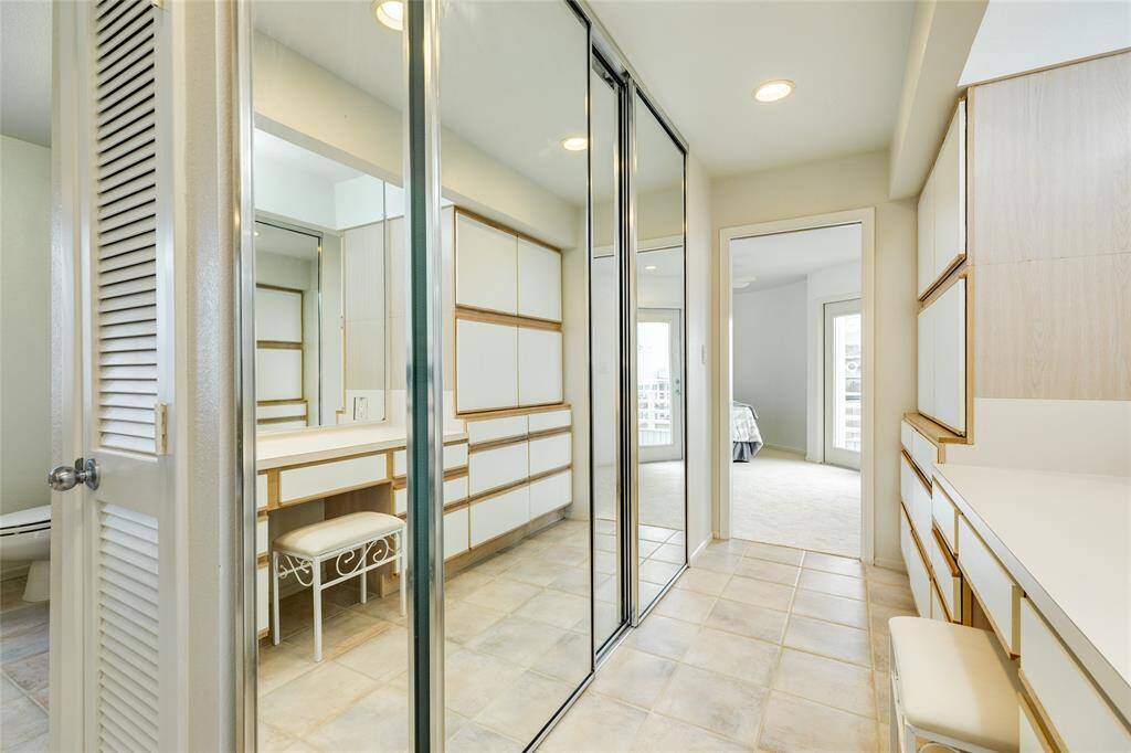 Notice the mirrored bypass closet doors. There's even a hidden locked cabinet.